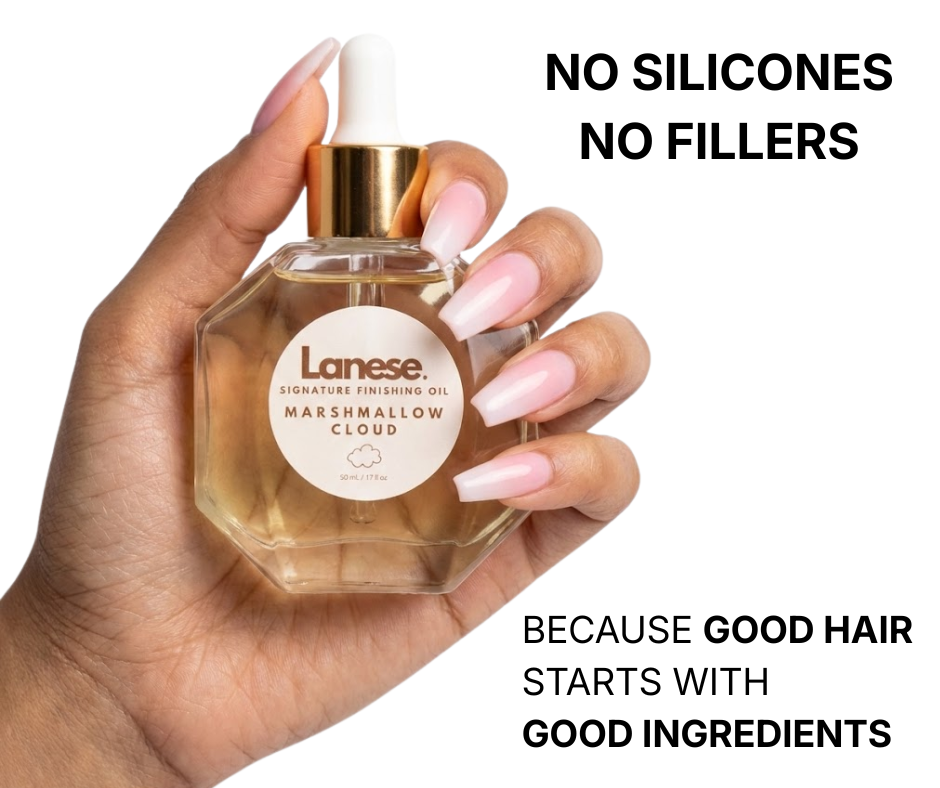 A hand with pink and white ombré nails holding a hexagon-shaped glass dropper bottle of Lanese hair oil against a plain white background. The light beige label reads: "Lanese. SIGNATURE FINISHING OIL. MARSHMALLOW CLOUD. 50 mL / 1.7 fl oz". Bold black text on the top right of the image reads: "NO SILICONES NO FILLERS". Text on the bottom right reads: "BECAUSE GOOD HAIR STARTS WITH GOOD INGREDIENTS".
