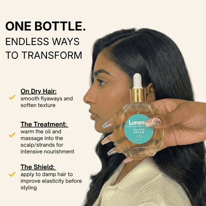 Side profile of a woman with dark hair. A hand with stylized nails holds the Island Dream oil bottle in the foreground. Text on the left lists three uses: "On Dry Hair" to smooth texture, "The Treatment" for intensive scalp and strand nourishment, and "The Shield" on damp hair to improve elasticity.