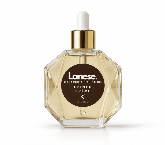 Lanese French Creme Signature Finishing Oil in a faceted clear glass bottle with a gold collar and white dropper cap, on a white background.