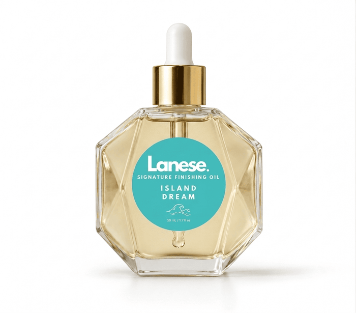 Lanese Signature Finishing Oil in the Island Dream scent, in a faceted clear glass bottle with a gold collar and white dropper cap, containing a pale yellow oil, on a white background.