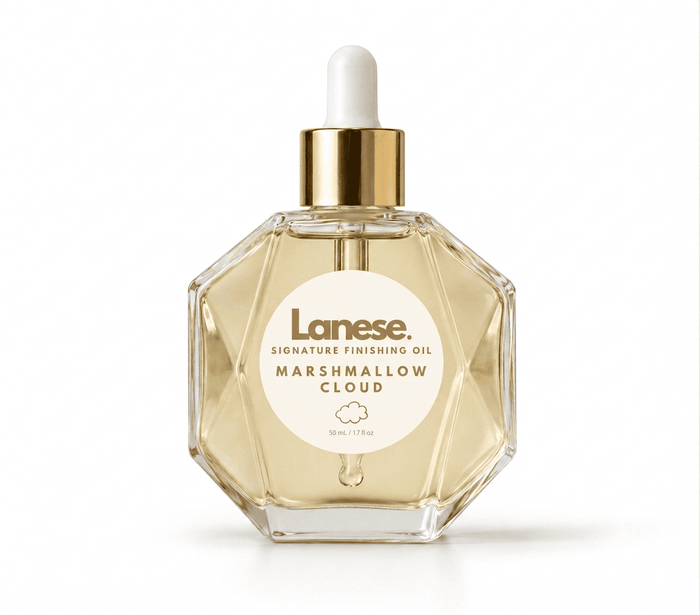 Lanese Signature Finishing Oil in Marshmallow Cloud scent, in a faceted clear glass bottle with a gold collar and white dropper cap, on a white background.