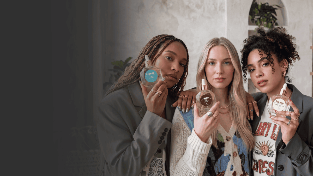 Lanese Beauty finishing hair oils held by three women with glossy healthy hair, showcasing silicone-free hair oil for shine, frizz control, softness, and all hair textures.
