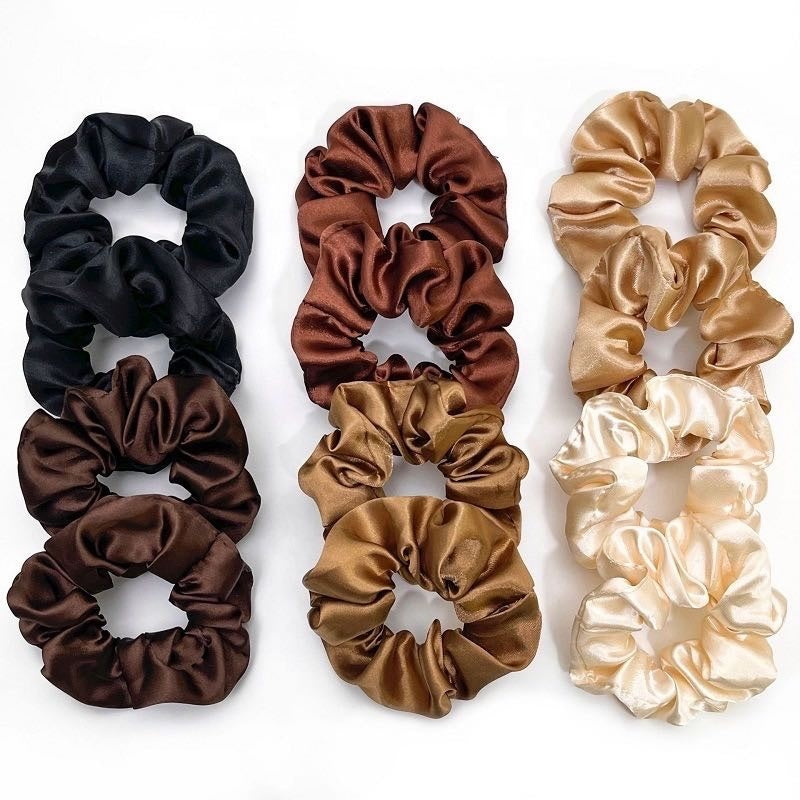 Set of eight satin scrunchies in various colors on a white background